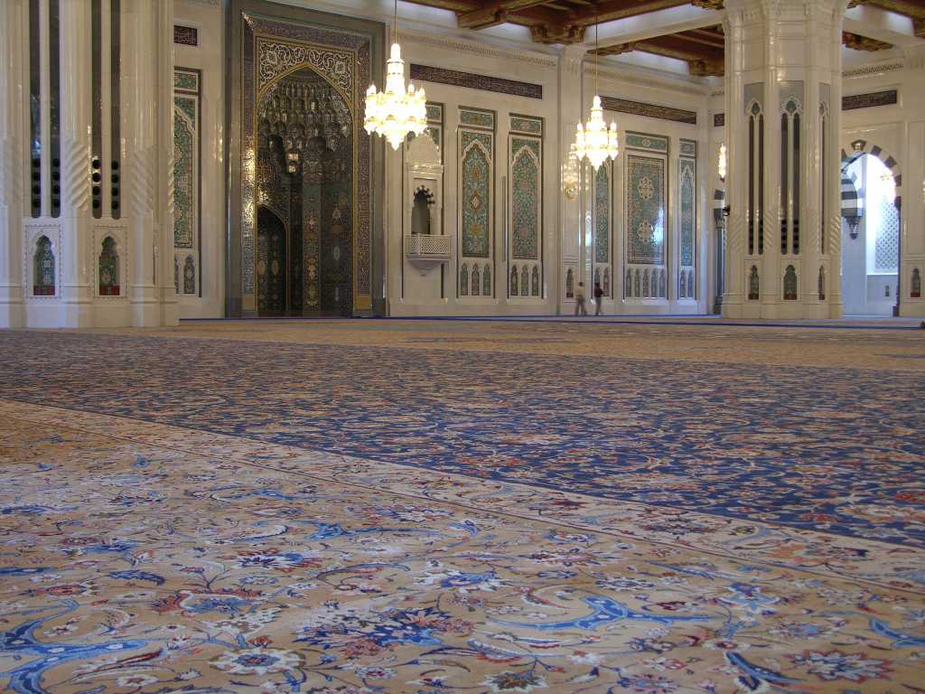 Muscat 04 Grand Mosque 06 Large Persian Carpet The main prayer hall has the largest carpet in the world, a 70m x 60m Persian carpet that took 600 women four years to weave. On the back wall is the mihrab, a niche in the wall facing Mecca. To the right of the mihrab is the minbar, a pulpit chair dating from the Prophet Mohammed�s time. The `imam', the one who leads the prayer, delivers the `khutba', the Friday sermon, which can deal with religious, social and political subjects.